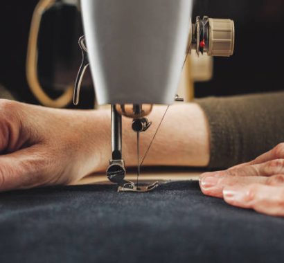 Vintage sewing machine and woman's hands, sewing process